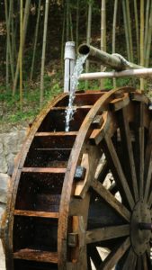 brown wooden wheel with water